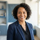 A smiling, diverse woman looking at the camera, representing a happy customer in a professional, bright setting.